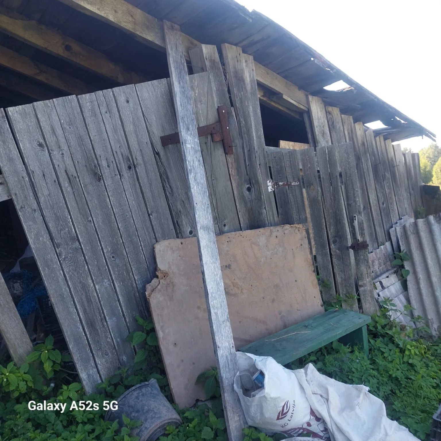 Close view of old barn doors and weathered boards with hardware.