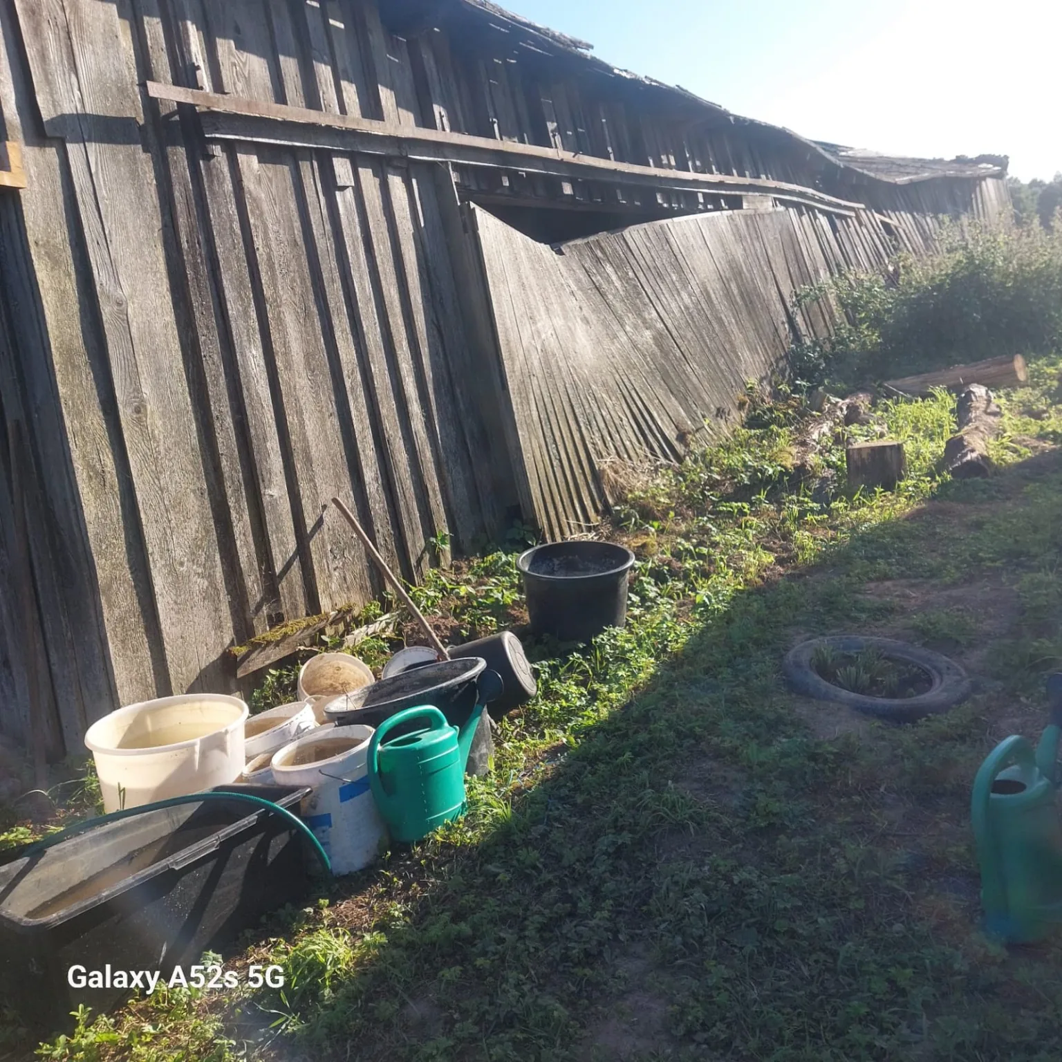 Long weathered barn wall with grey patina boards before dismantling.