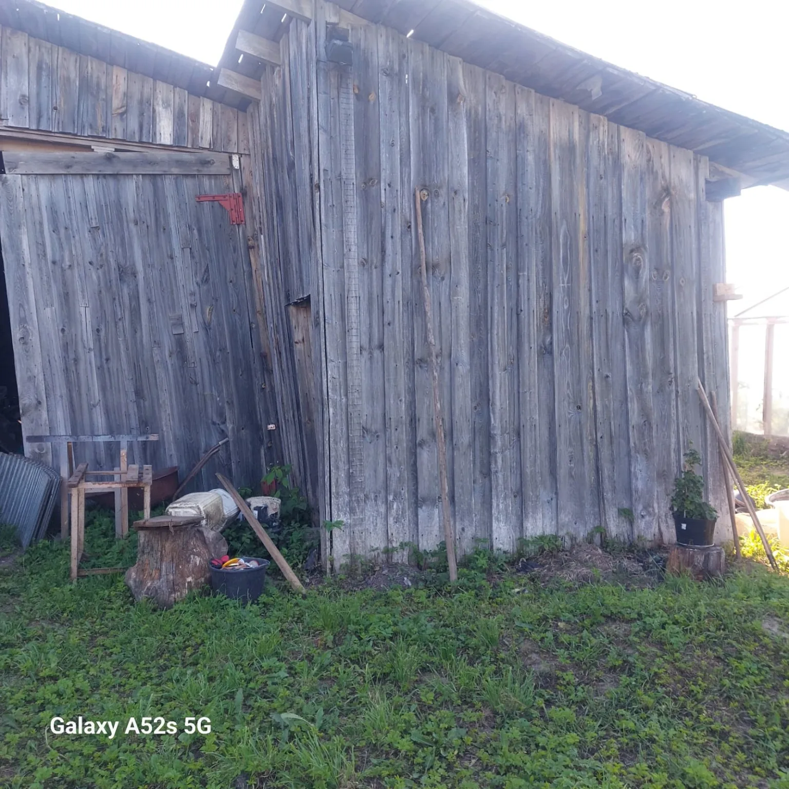 Side wall of old barn with vertical grey boards and rustic texture.