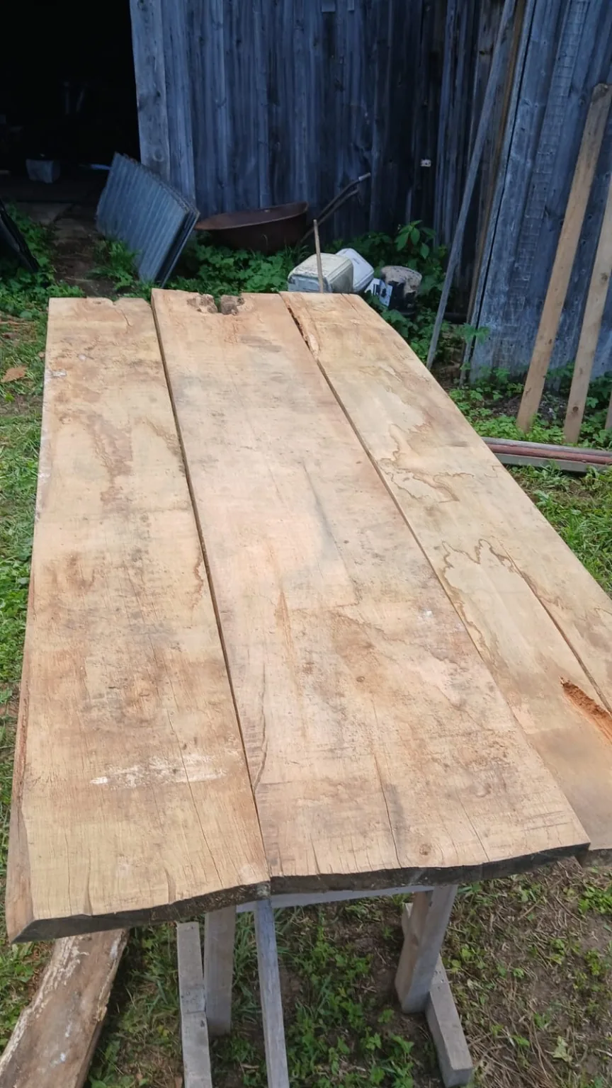 Cleaned oak boards arranged in a rustic tabletop layout.